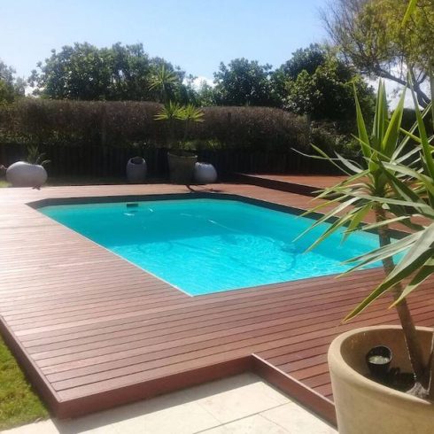 Teak deck installed around a pool with EasyClips